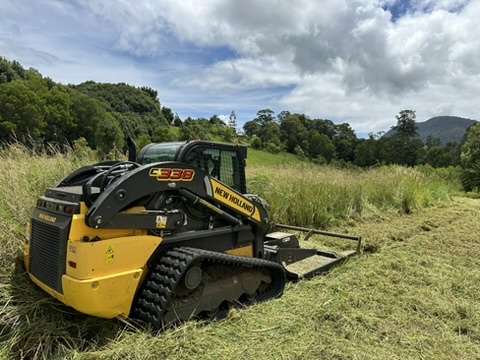 Professional acreage mowing service by Stone & Rubble, showcasing efficient land care and property maintenance equipment.